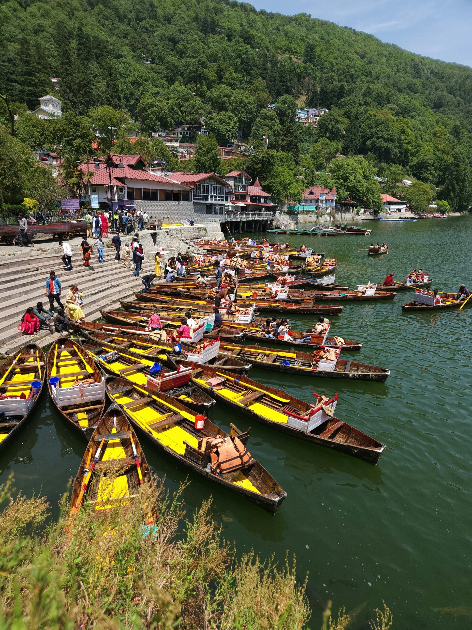 Colorful boats docked at the beautiful Nainital Lake, a popular tourist destination in India.